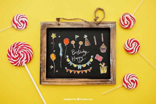 Free PSD birthday concept with lollipops and slate