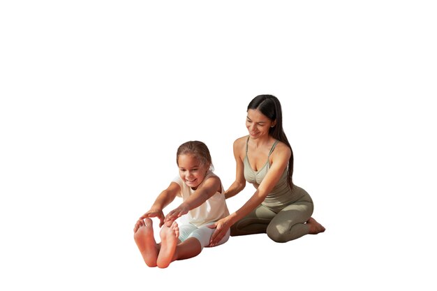 Female yoga instructor doing meditation with young girl