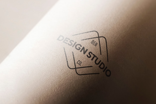 Free PSD logo mockup in curved paper