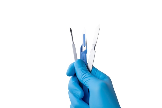 Surgical scalpel held by hand with glove