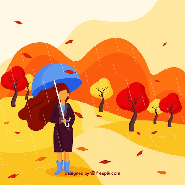 Autumn background with woman holding umbrella