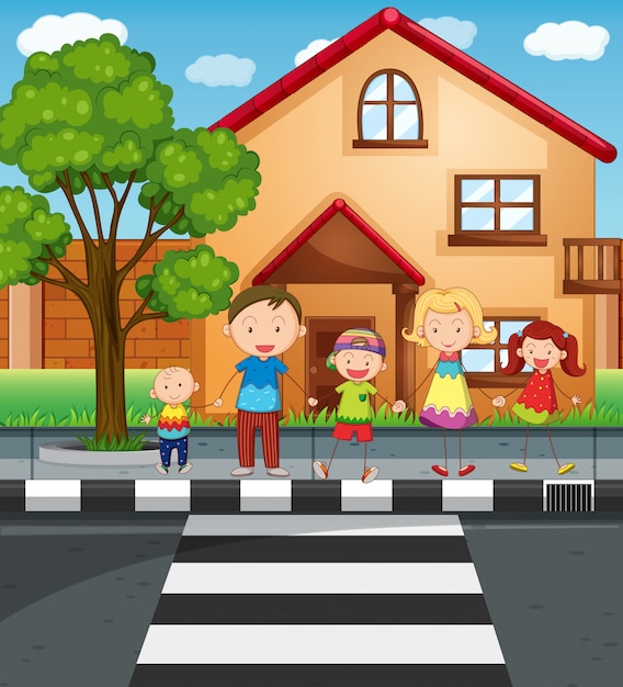 Family holding hands while crossing the road