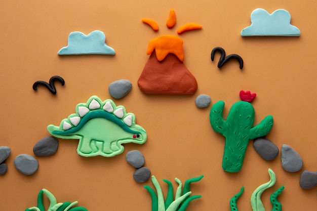 Photo gratuit art de la pâte à modeler avec dinosaure et volcan