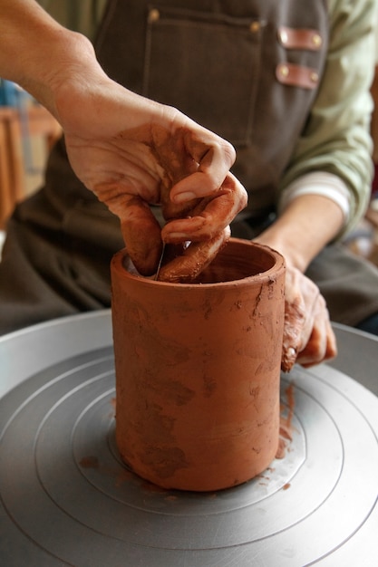 Photo gratuit artisan de poterie dans le studio créant la céramique