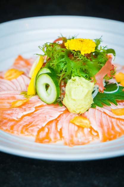 Carpaccio de saumon dans une assiette blanche