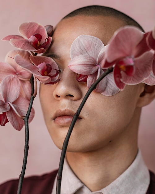 Homme couvrant les yeux avec des fleurs