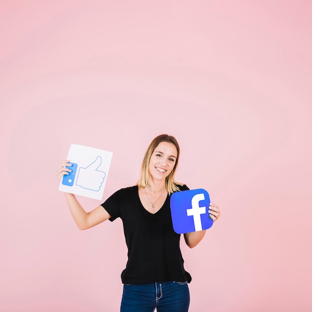 Photo gratuite portrait d'une femme heureuse avec facebook pouce en l'air icône