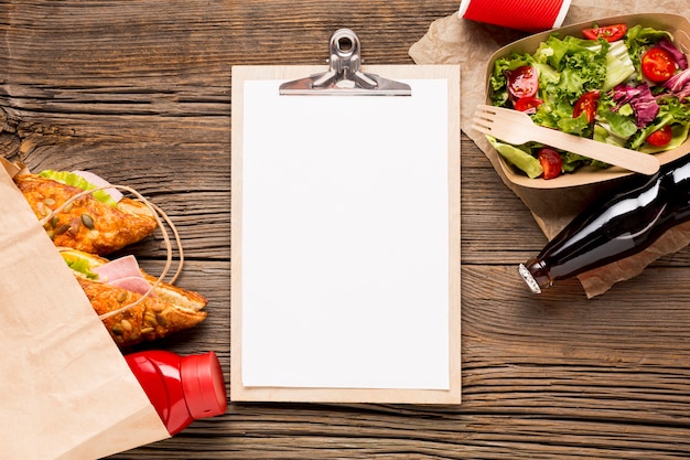 Photo gratuite presse-papiers vide avec fast food et soda