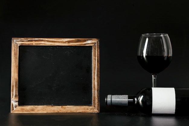 Photo gratuite tableau près de la bouteille et du verre à vin