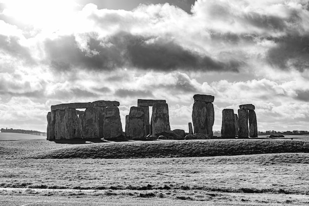 Photo gratuit tourné en niveaux de gris du stonehenge en angleterre sous un ciel nuageux