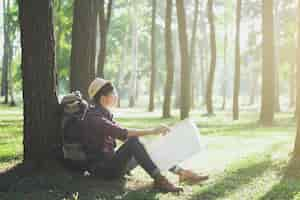 Photo gratuite voyageur avec sac à dos relaxant en plein air.