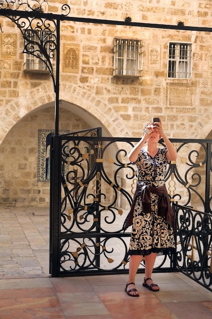 Photo une femme debout contre un mur de briques.