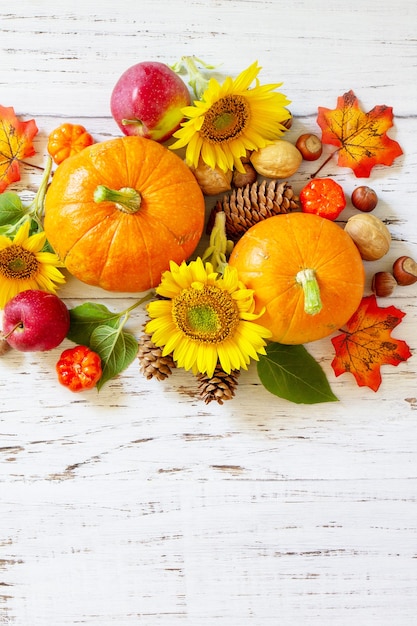 Happy Thanksgiving concept citrouilles tournesols pommes et feuilles tombées vue de dessus espace copie