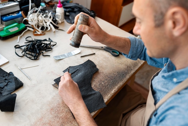 Homme travaillant seul dans un atelier de cuir