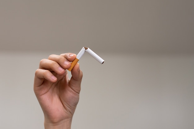 Mains tenant et cassant la cigarette pour arrêter de fumer Arrêter de fumer pour le concept de santé