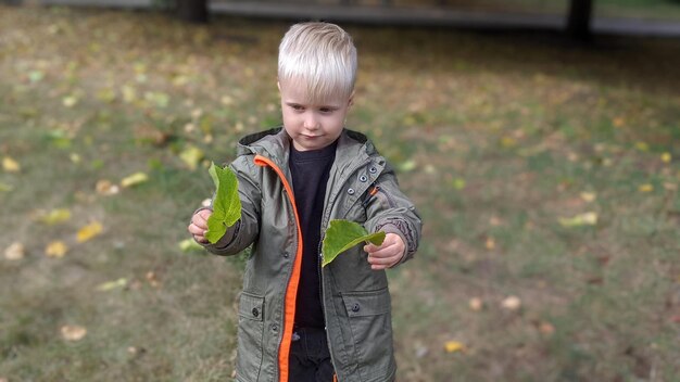 mignon drôle garçon enfant blond dans la rue dans le parc