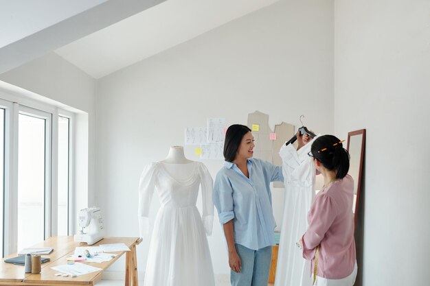 Photo tailleur montrant la robe de mariée au client