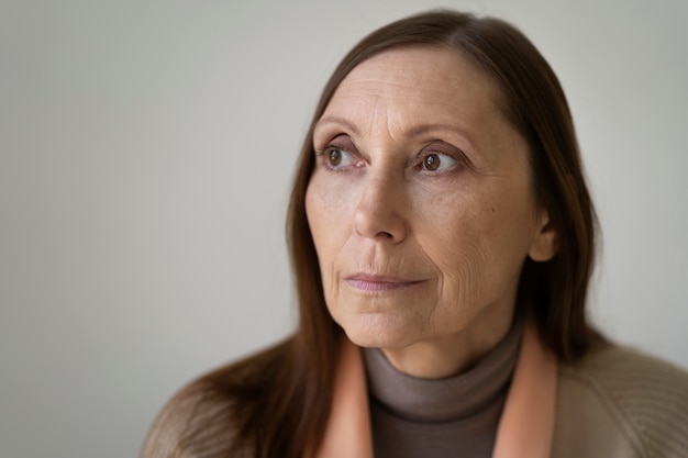 Vue de face vieille femme posant à l'intérieur