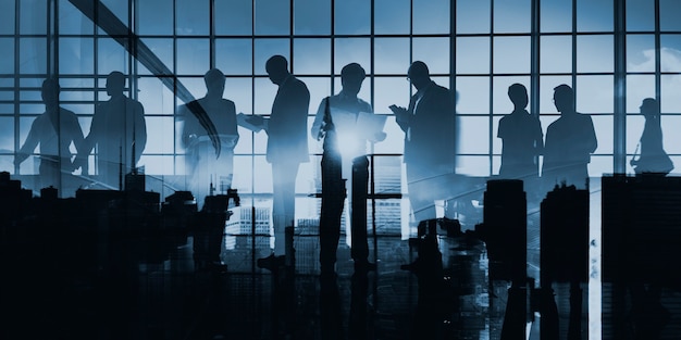 Abstract image of business people silhouette on glass window