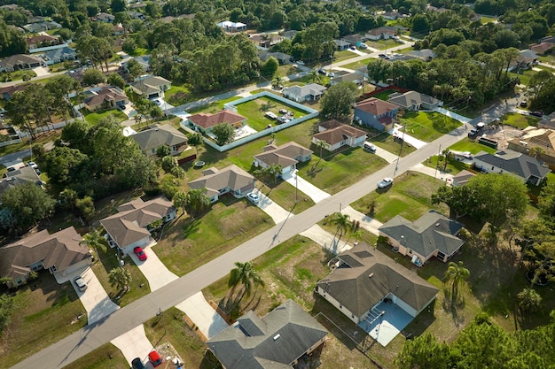 Aerial landscape view of suburban private houses between green palm trees in Florida quiet rural area