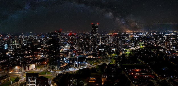 Aerial shot of Manchester, UK at night. Night skyscrapers standing in the city lights.