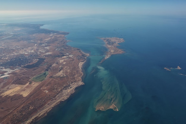 Aerial view from plane on seascape with coastal city in Turkey. Flying over the Istanbul and sea on the airplane, view from window.