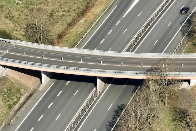 Aerial view of highway road intersection with fast moving heavy traffic Intercity transportation with many cars and trucks