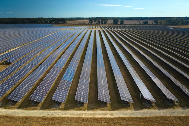 Aerial view of large sustainable electrical power plant with rows of solar photovoltaic panels for producing clean electric energy Concept of renewable electricity with zero emission