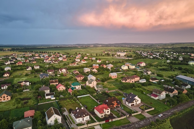 Aerial view of residential houses in suburban rural area at sunset