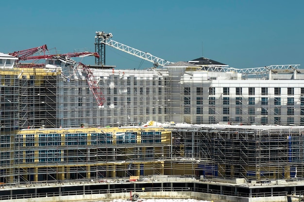 Aerial view of ruined by hurricane Ian construction crane on high apartment building site in Port Charlotte USA