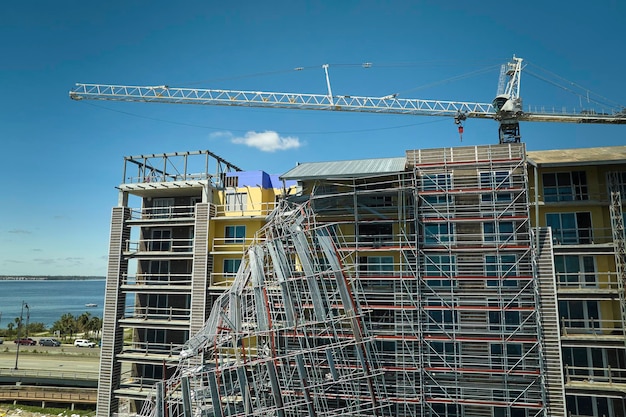 Aerial view of ruined by hurricane Ian construction scaffolding on high apartment building site in Port Charlotte USA