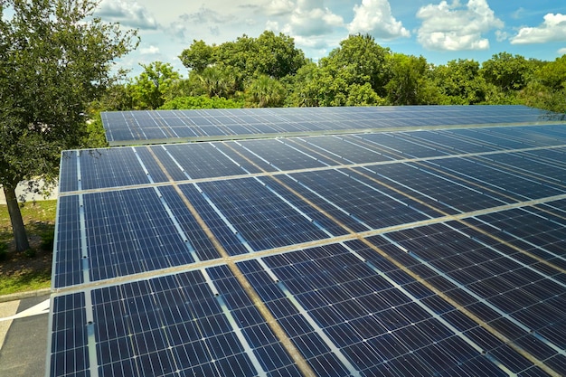 Aerial view of solar panels installed as shade roof over parking lot for parked cars for effective generation of clean electricity Photovoltaic technology integrated in urban infrastructure