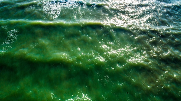 Photo aerial view waves on sand beach. sea waves on the beautiful beach aerial view drone 4k shot.