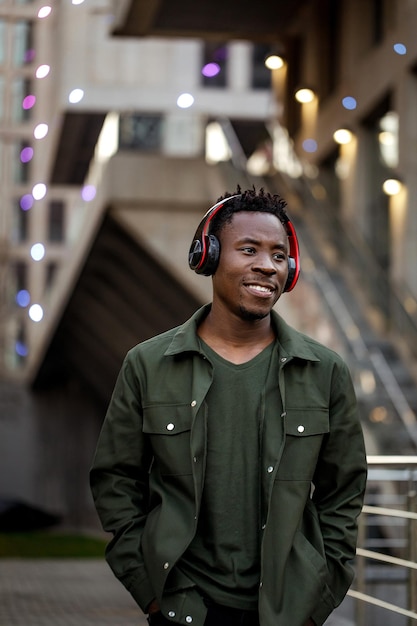 Africanamerican man in wireless headphones listening music