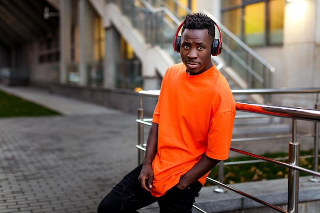 Africanamerican man in wireless headphones listening music