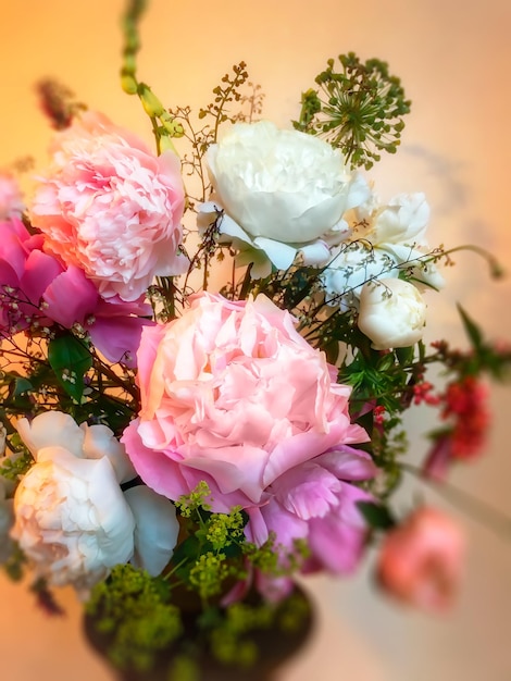 Art of arranging bouquets of flowers Soft focus blurred image of a romantic bouquet In composition peonies geykhera allium foxglove