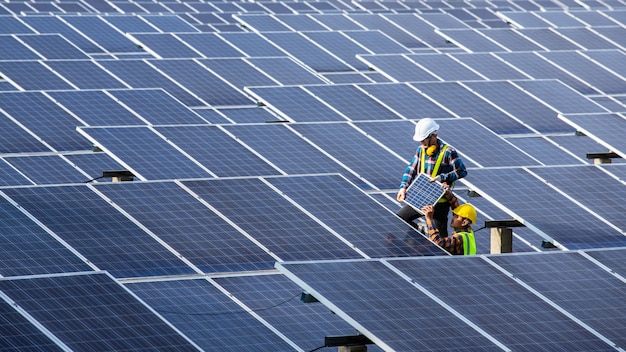 Photo asian engineer working on checking equipment in solar power plant, pure energy, renewable energy