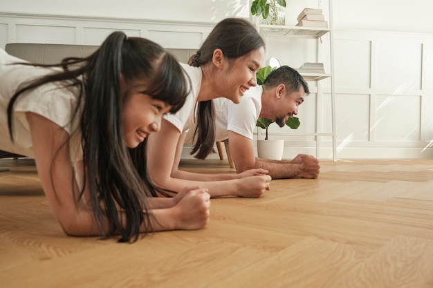 Photo asian thai family fitness training and practice yoga in the living room