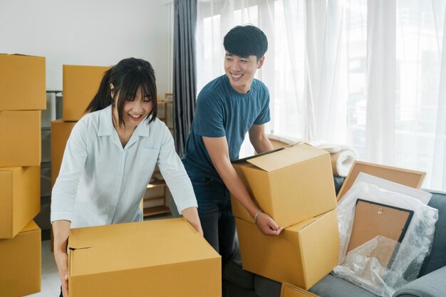 Photo asian young happy new married couple moving to their new house or real estate an attractive romantic