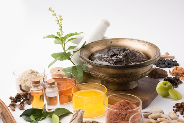 Ayurvedic Chyawanprash is a Powerful  Immunity Booster OR Natural Health Supplement. Served in an Antique bowl with Ingredients, over moody background, selective focus