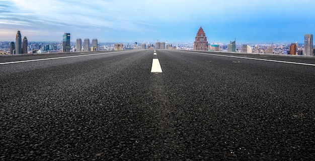 Background of asphalt pavement and urban architectural landscape skyline