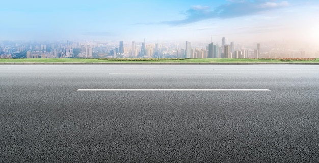 Background of asphalt pavement and urban architectural landscape skyline