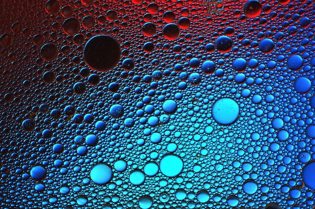 Background of colorful oil drops in water surface - abstraction