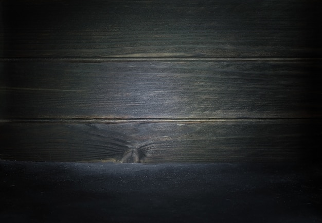 Photo background table dark on the background of a wooden wall