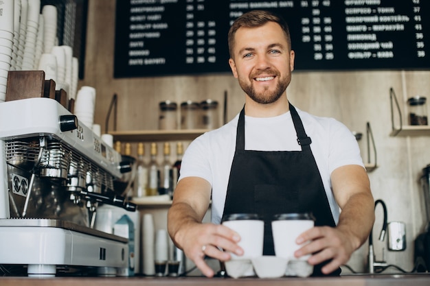 Barista standing by the counter in a coffee shop