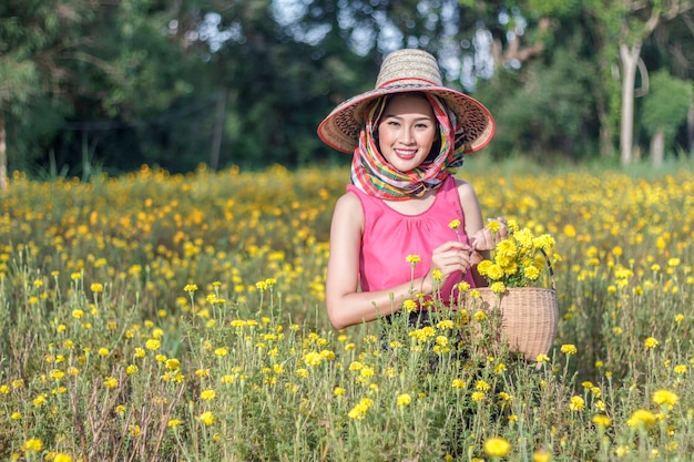 Beautiful asian gardener girl in marigold flowers field 