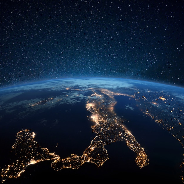 Beautiful blue planet earth with night city lights. Central Europe and Italy at night view from space. Modern cities and electricity
