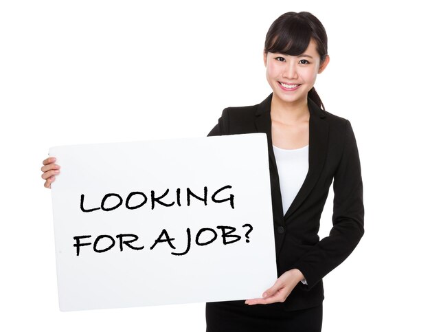 Photo beautiful businesswoman showing a poster showing with looking for a job phrases