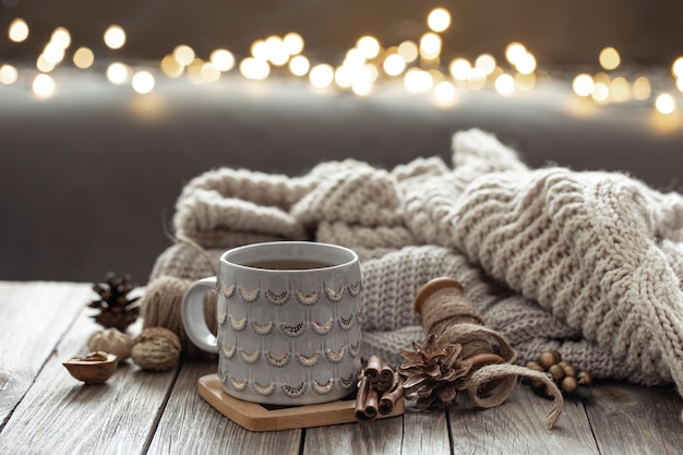 Beautiful christmas cup and candles on blurred background with bokeh