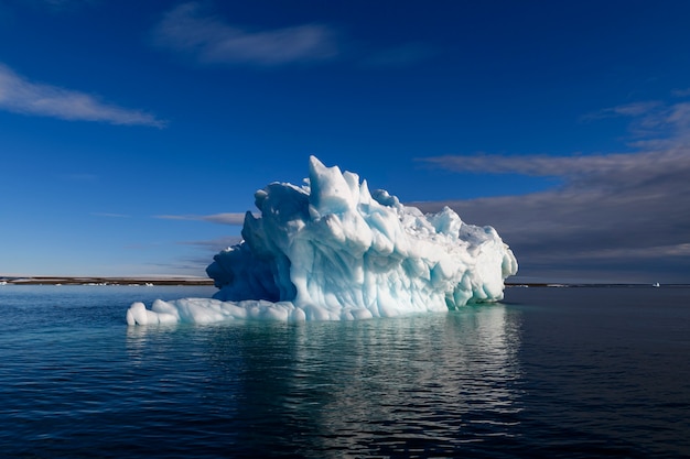 Beautiful iceberg in Arctic sea at sunny day. Big piece of ice in sea close up.